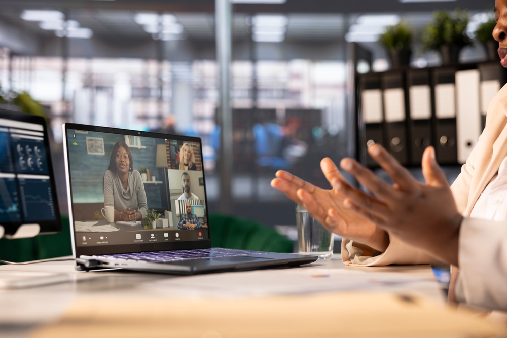 Businesswoman With Employees In Videocall